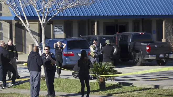 Jefferson Parish Sheriff’s Office deputies investigate a shooting at the Jefferson Gun Outlet in Metairie, Louisiana