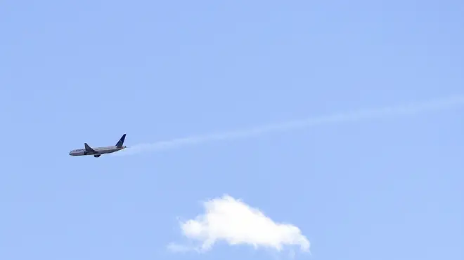 The United Airlines plane with smoke trailing from its right side is seen heading towards Denver International Airport on Saturday