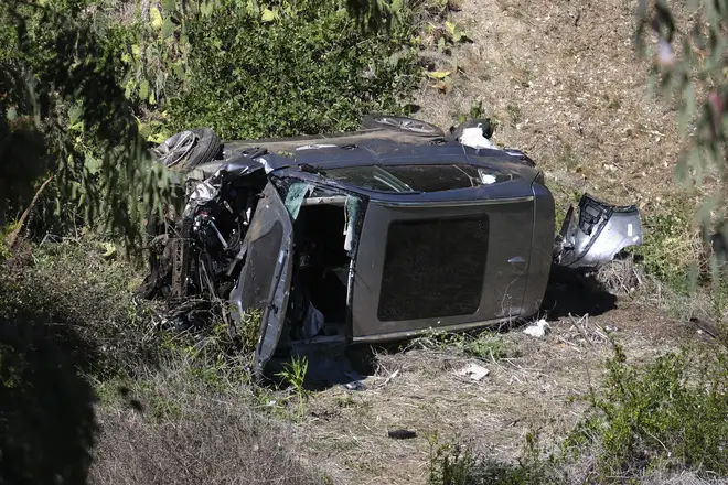 A vehicle rests on its side after a rollover accident involving golfer Tiger Woods
