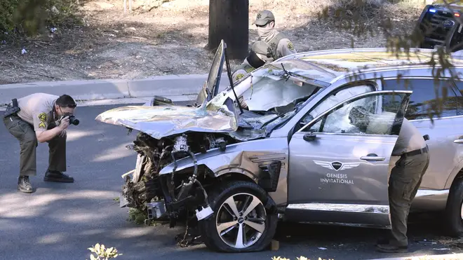 Tiger Woods mangled car is photographed by police after the crash