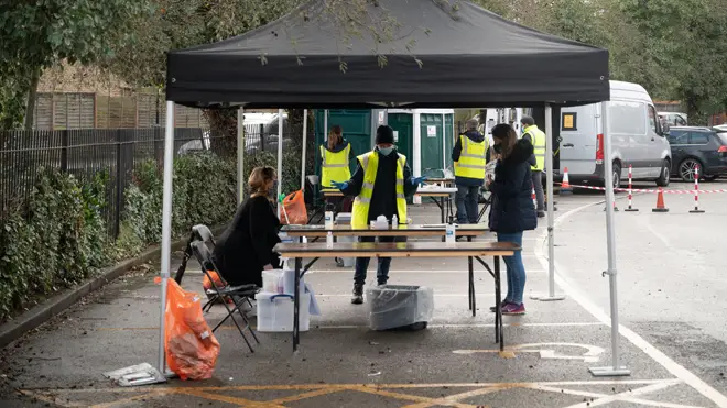 People have coronavirus tests at a temporary COVID-19 testing facility set up in Ealing