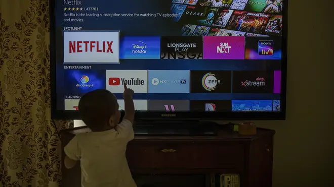 A child touches a TV screen