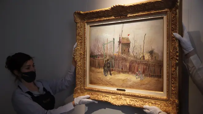 Sotheby’s personnel display the painting by Vincent van Gogh