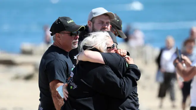 Harry's family embrace as they scatter his ashes