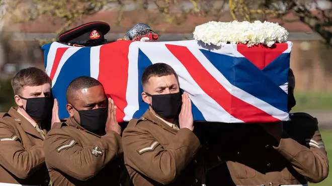 The coffin of Captain Sir Tom Moore is carried by members of the armed forces during his funeral