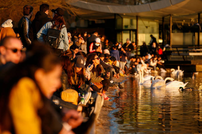 Many people sat by the Serpentine lake in Hyde Park on Saturday evening.