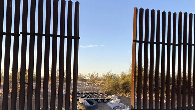 The hole cut into the US border fence in southern California