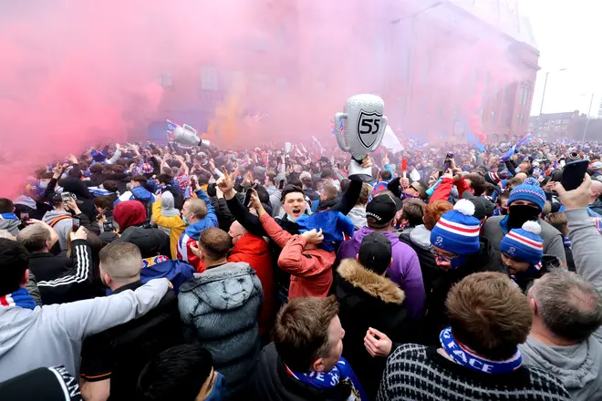 Rangers fans celebrate outside of the Ibrox Stadium