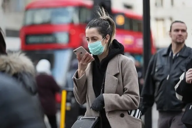 A woman wearing a face mask mask in Oxford Street in London.