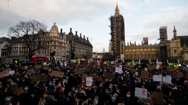 Members of the public hold up signs during a protest in Parliament Square against the The Police, Crime, Sentencing and Courts Bill