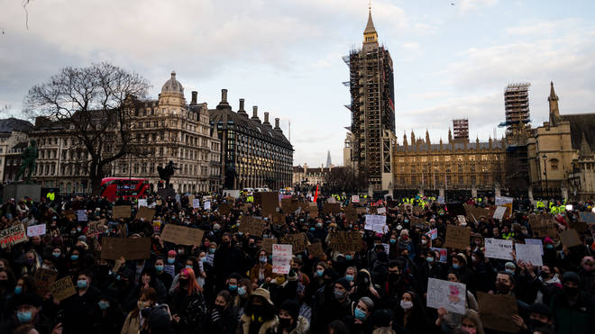 Members of the public hold up signs during a protest in Parliament Square against the The Police, Crime, Sentencing and Courts Bill