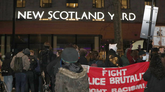 Campaigners unveiled a 'fight police brutality' banner outside New Scotland Yard