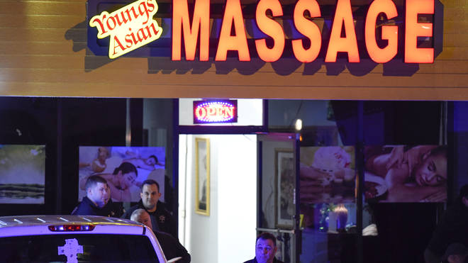 Authorities investigate a fatal shooting at a massage parlo