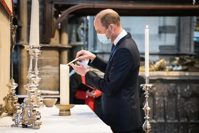 Prince William lights a candle at Westminster Abbey