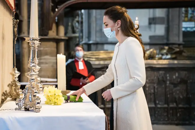The Duchess of Cambridge lights a candle at Westminster Abbey