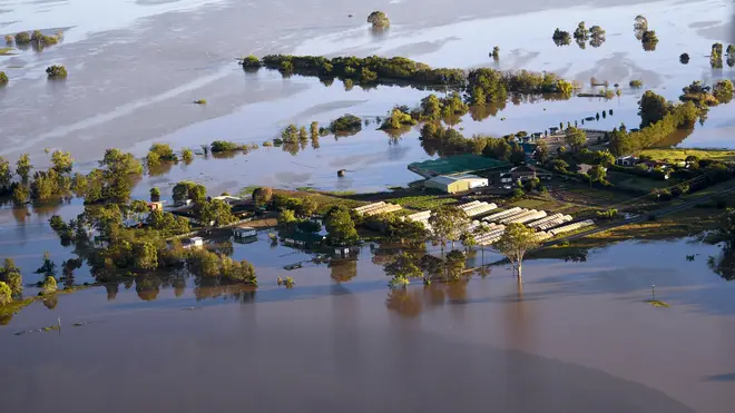 Buildings are partially submerged as floodwater covers large areas north west of Sydney