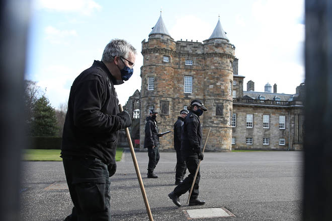 Police carrying long sticks were seen combing the forecourt outside Holyroodhouse on Wednesday morning