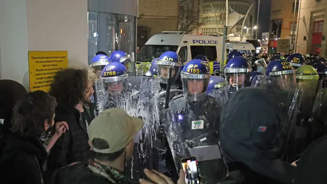 Police officers and protesters in Bristol on Saturday evening