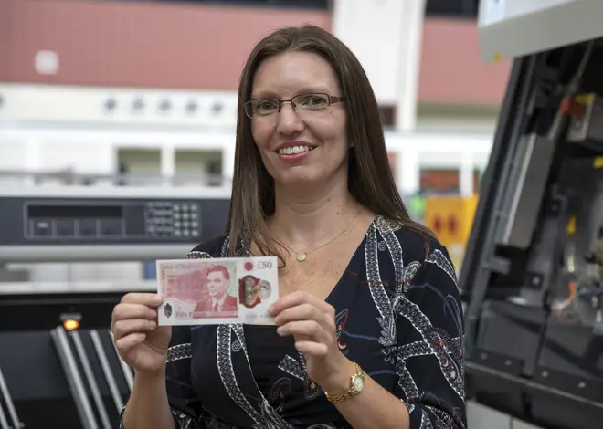 Sarah John, Chief Cashier at the Bank of England, holding the new £50 note featuring scientist Alan Turing