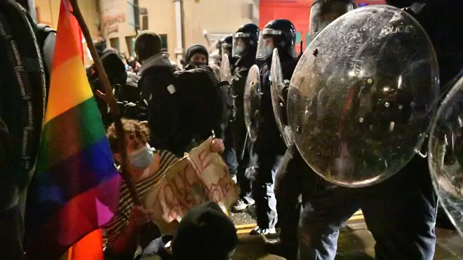 Protesters face off against police in riot gear in Bristol