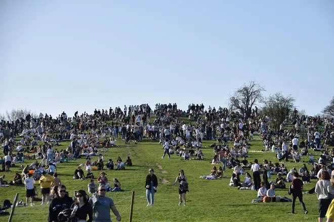 Police were called to reports of a "man armed with knife behaving erratically" as hundreds gathered at Primrose Hill on Tuesday evening.