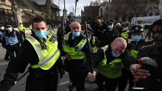 Police push back protesters during a Kill The Bill demonstration outside of the Houses of Parliament.