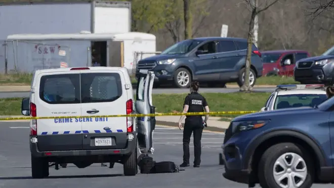 A crime scene technician stands near the scene of a shooting at a business park in Frederick, Maryland (Julio Cortez/AP)