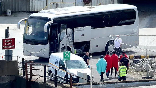 Border Force officers escort men thought to be migrants to a waiting bus in Dover (file image)