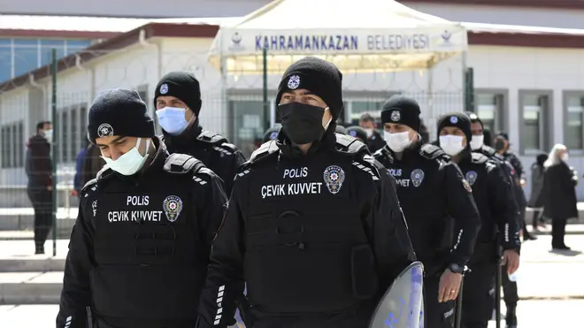 Riot police officers leave a courthouse during the trial of 497 defendants, in Sincan, outside the capital Ankara, Turkey (Burhan Ozbilici/AP)
