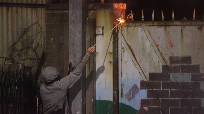 Fireworkers were launched at groups of people on both sides of the Belfast peace lines