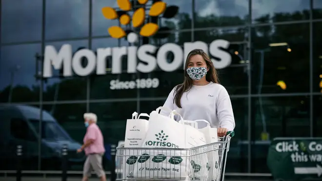 A woman using Morrisons paper bags for her shopping