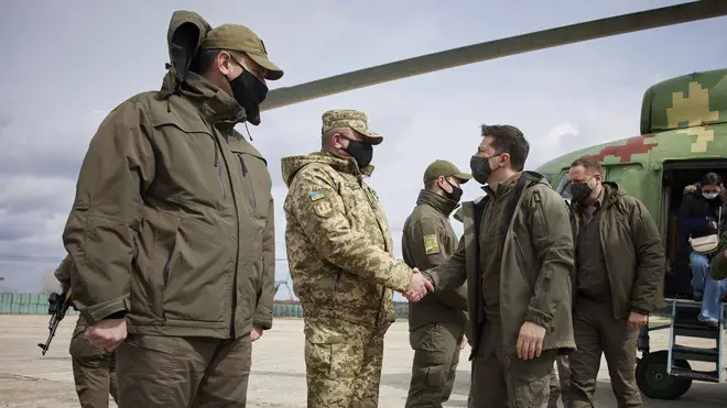Ukrainian President Volodymyr Zelenskiy shakes hands with a soldier as he visits the war-hit Donetsk region (AP)