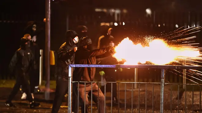 Rioters were seen throwing fireworks at police officers in west Belfast