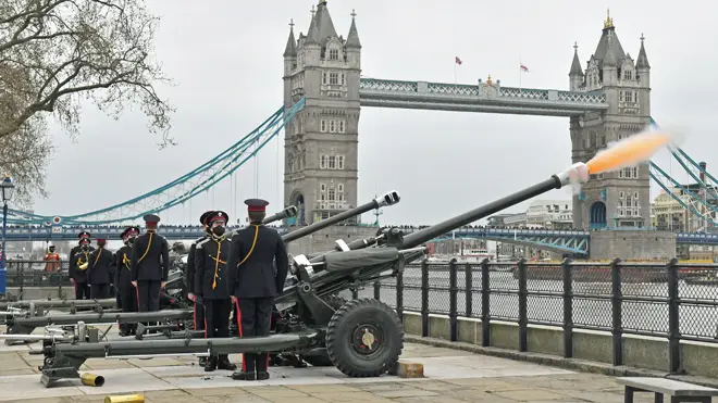 Members of the Honourable Artillery Company fire a 41-round gun salute from the wharf at the Tower of London