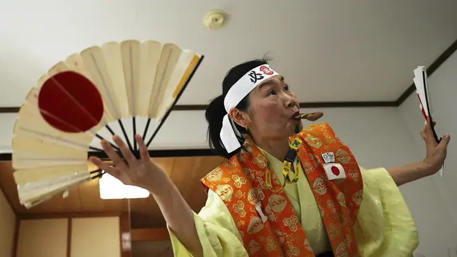 Olympic fan Kyoko Ishikawa shows her cheering at her home in Tokyo