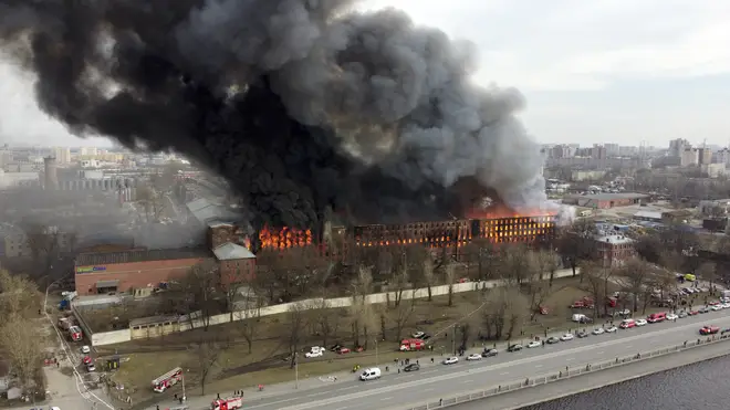 Smoke and flames rise from a building in St Petersburg, Russia