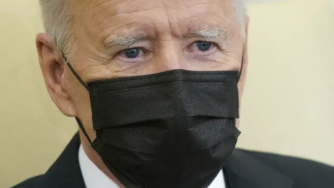 Joe Biden wearing black face mask over his nose and mouth