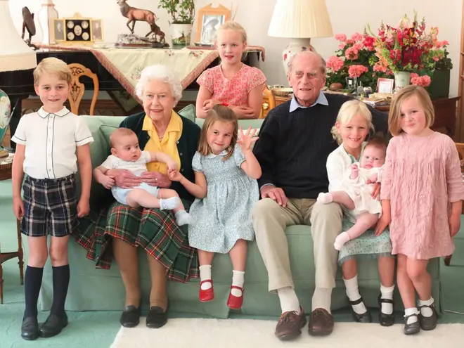 The Royal Family have released previously unseen pictures of Prince Philip, pictured here with the Queen and seven of their great-grandchildren