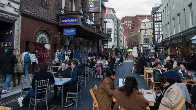 Crowds fill tables in Old Compton Street in Soho