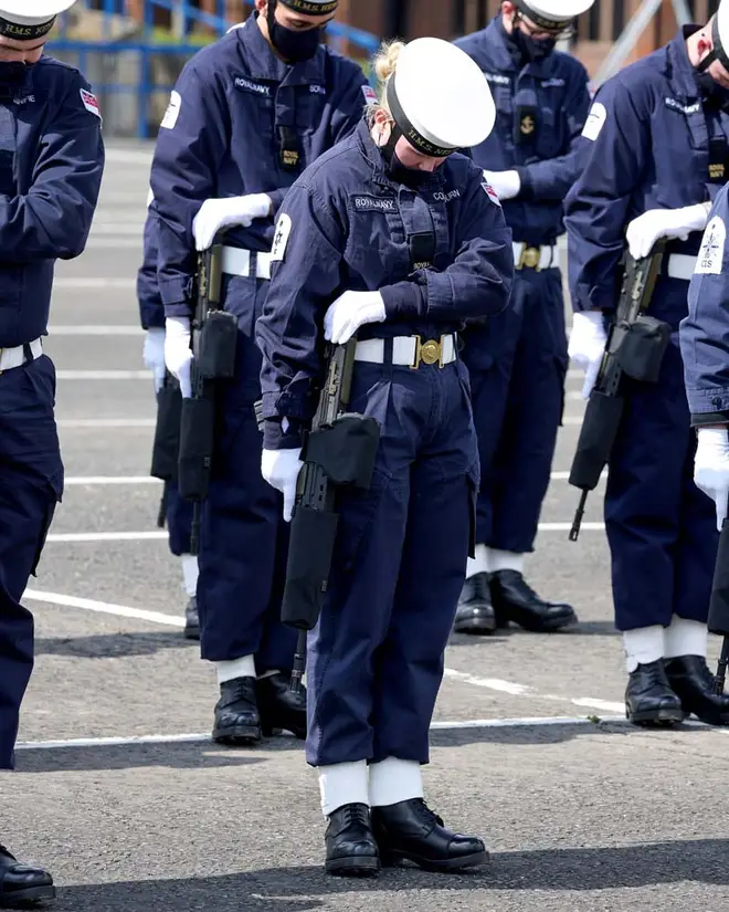 A Royal Navy rating bows her head