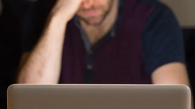 A man looking at a computer