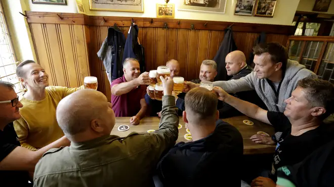 Customers cheer with beer at a pub in Prague, Czech Republic