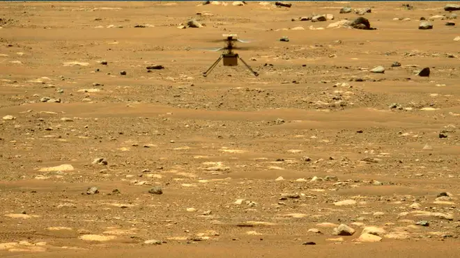 The Mars Ingenuity helicopter hovers above the surface of the planet during its second flight