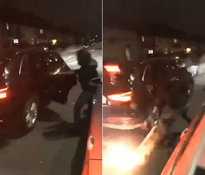 A hooded man throws a lit firework into a stranger's car