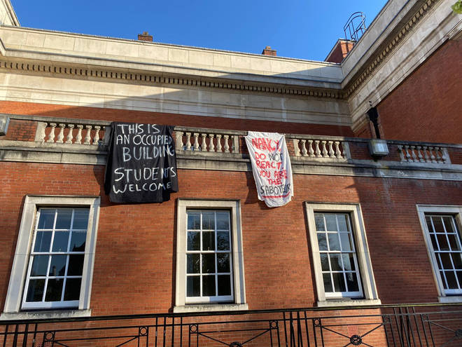 Students occupying University of Manchester buildings unfurled banners on Friday morning