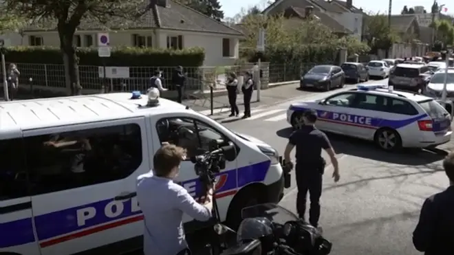 Police near the scene of a stabbing at a police station in Rambouillet, south-west of Paris