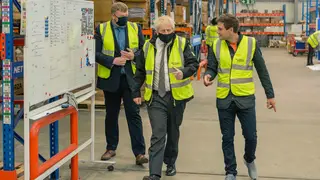 Boris Johnson walks in the warehouse of Next World Sports during his visit to Wrexham