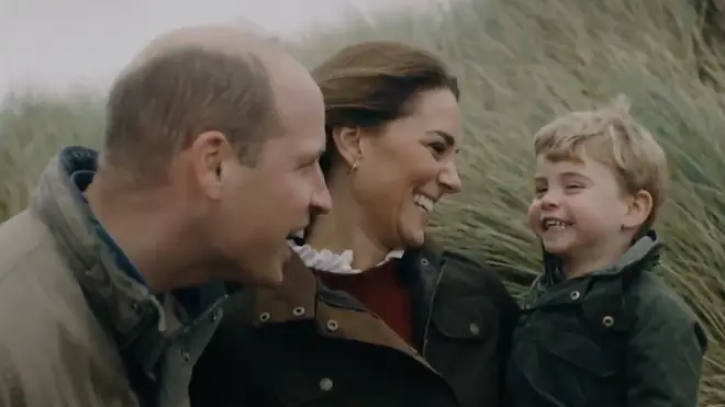 The couple smile at their youngest son Prince Louis in the clip