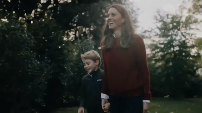 Prince George smiles as he walks with his Mum