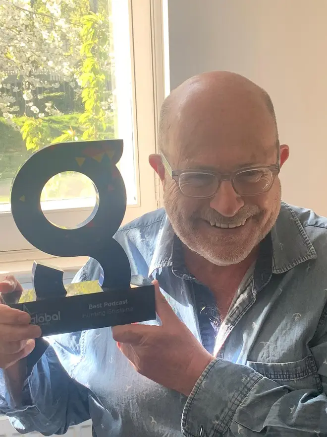 John Sweeney displays his award